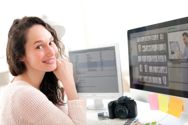 Young woman photographer working in her office — Stock Photo, Image