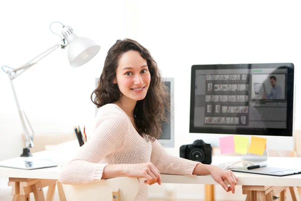 Young woman photographer working in her office — Stock Photo, Image