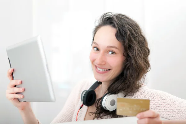 Young relaxed woman shopping on a tablet — Stock Photo, Image