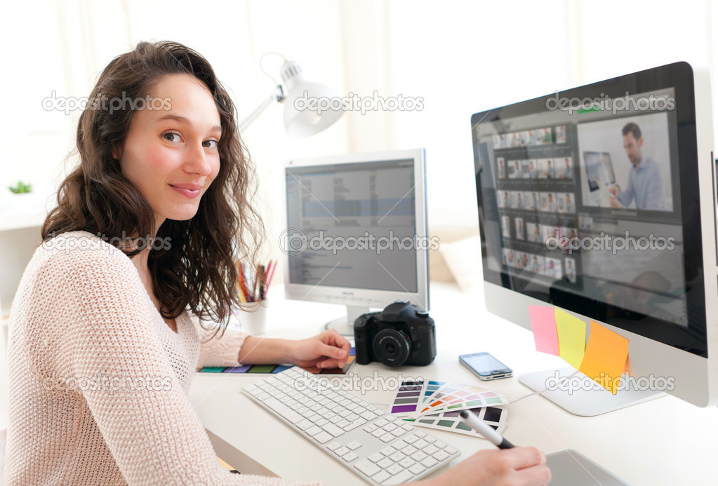 Young woman photographer working in her office