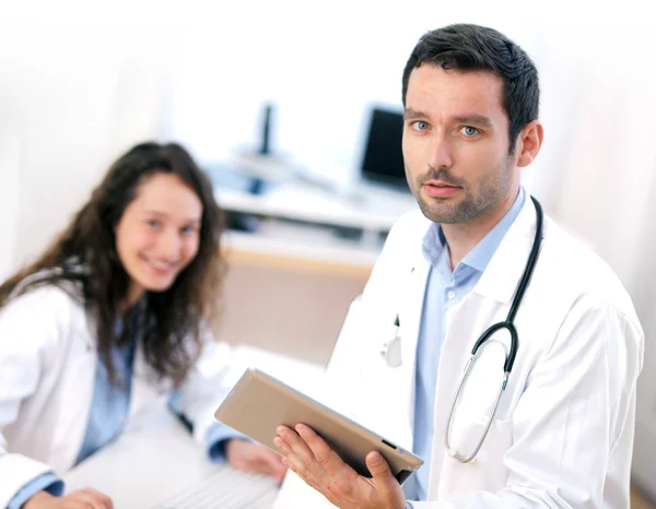 Portrait of a doctor using tablet and a nurse — Stock Photo, Image