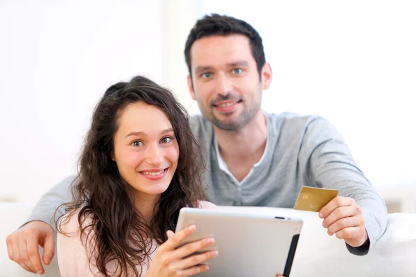 Молода щаслива пара купує на планшеті — стокове фото