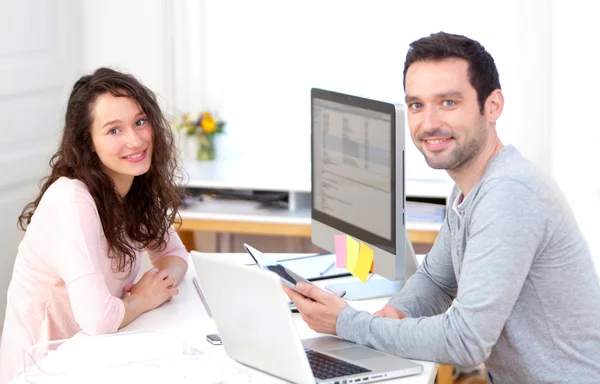 Young attractive co-workers at the office — Stock Photo, Image