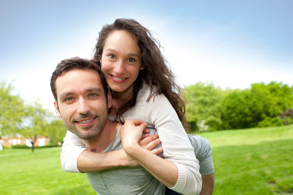 Jovem casal feliz se divertindo no parque — Fotografia de Stock