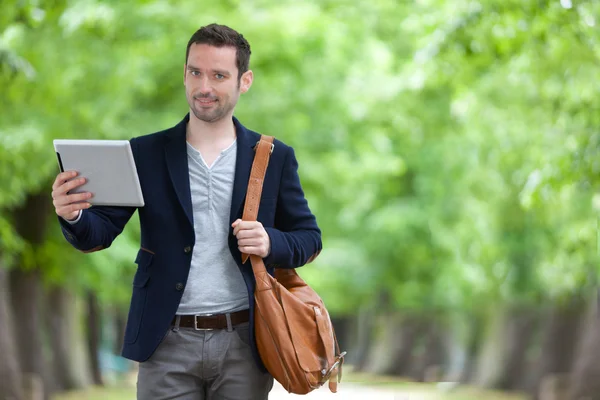 Young attractive man using tablet in Paris — Stock Photo, Image