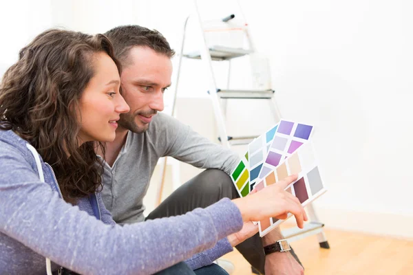 Casal jovem escolhendo cores de seu novo apartamento — Fotografia de Stock