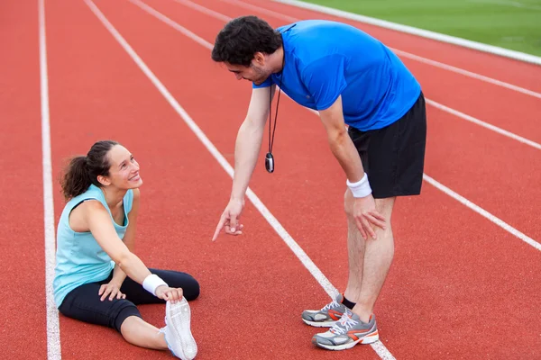 Young attractive woman stretching her leg — Stock Photo, Image