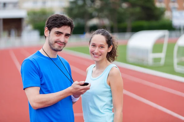 Sport coach training a young attractive woman — Stock Photo, Image