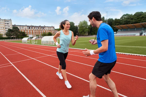 Sport coach training a young attractive woman — Stock Photo, Image