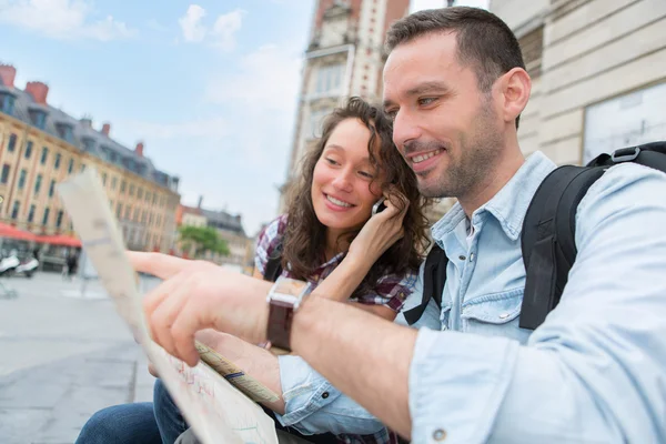 Young couple of tourists booking an activity — Stock Photo, Image