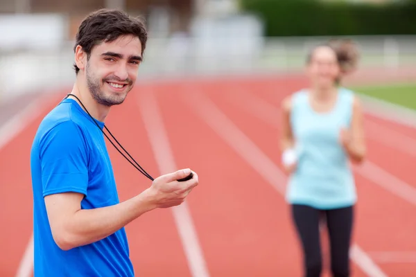 Sport coach training a young attractive woman — Stock Photo, Image