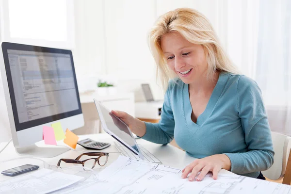 Blonde architect watching blueprint at the office — Stock Photo, Image