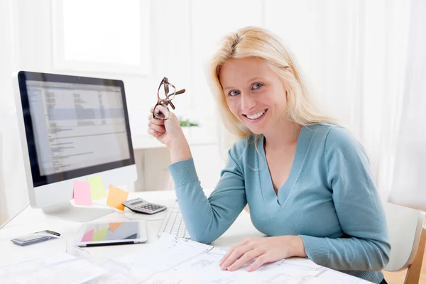 Blonde architect watching blueprint at the office — Stock Photo, Image