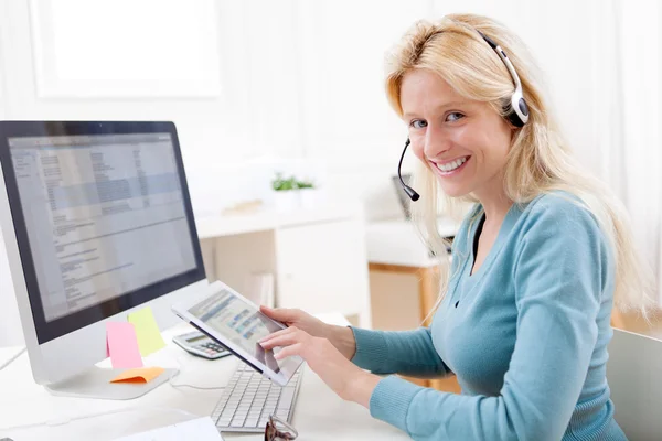 Young attractive blonde working in a call center — Stock Photo, Image