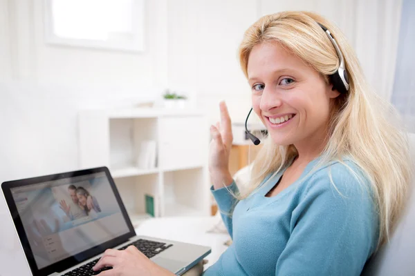 Young attractive woman blonde chatting on laptop — Stock Photo, Image