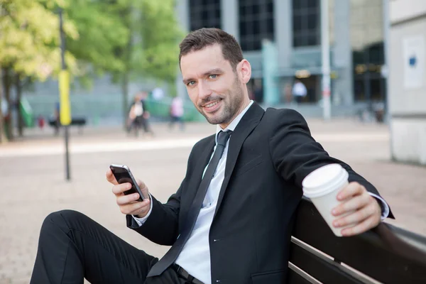 Businessman drinking a coffee during a break — Stock Photo, Image