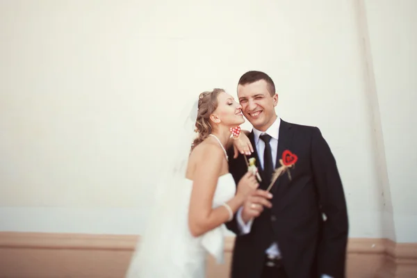 Bride and groom with hearts on sticks — Stock Photo, Image