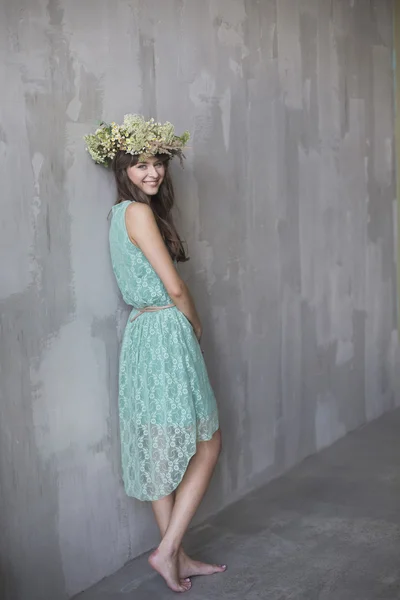 Beautiful brunette girl with a wreath in her hair — Stock Photo, Image