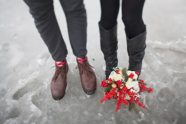 Kobieta i mężczyzna w parku w zimie z bukiet czerwony kwiat — Zdjęcie stockowe