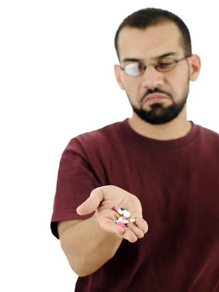 Homem repugnante muitos comprimidos na palma da mão, isolado — Fotografia de Stock