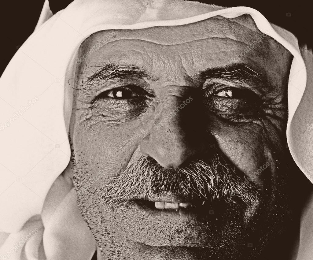 Old photo with grain added, face of aged arabic man