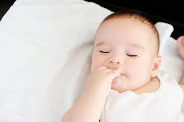 Baby on leather sofa — Stock Photo, Image