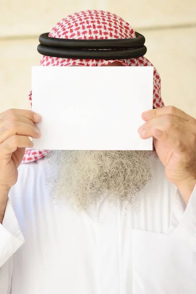 Man with long beard posing with empty copy space paper on his face — Stock Photo, Image