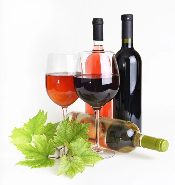 Wineglass, bottle of wine and grapes leaf — Stock Photo, Image