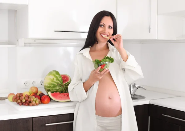 Pregnant woman with fruits and salad Stock Picture