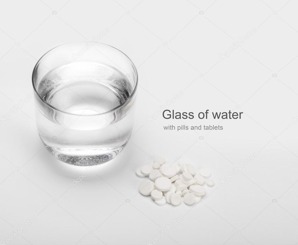 tablets and pills and glass of water