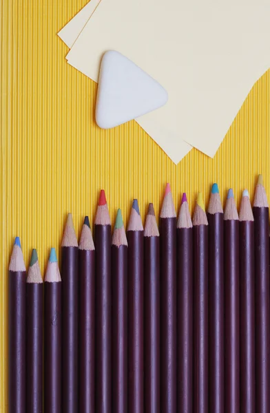 Karton arka plan üzerinde renkli kalemler — Stok fotoğraf