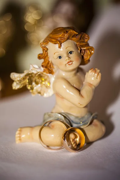 Wedding ring and little angel — Stock Photo, Image