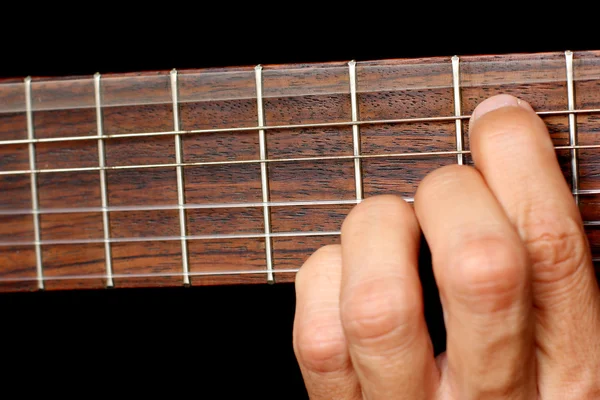 Hand, hold a chord on the guitar fretboard, vibrating string — Stock Photo, Image