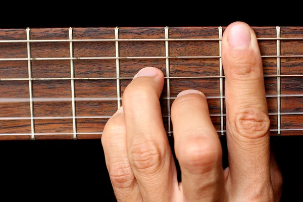 Hand holding a chord, and vibrating strings — Stock Photo, Image