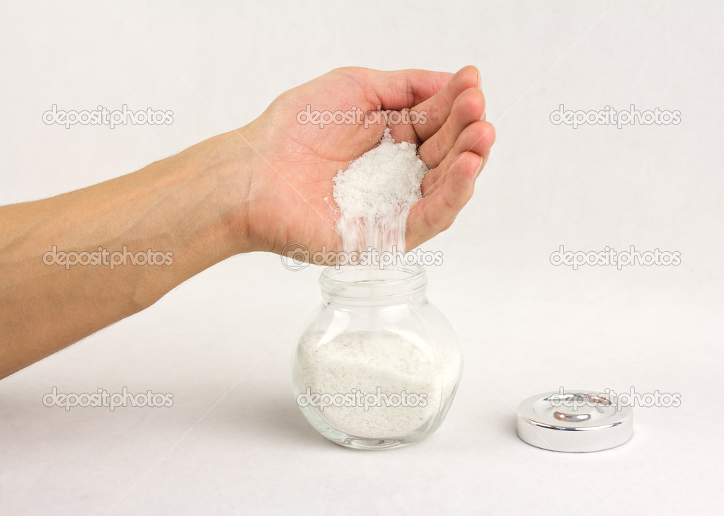 human hand is strewing salt 