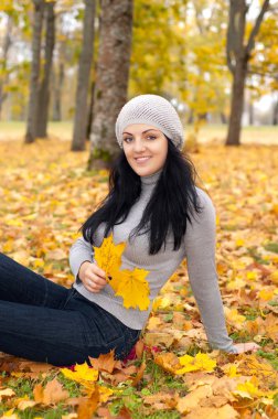 Güz ormanında güzel genç bir kadın.