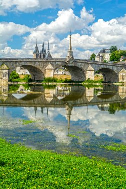 Blois, Loire Valley, France: Blois skyline, city on the shores of Loire River with Jacques Gabriel bridge, capital of Loir-et-Cher department in central France, dramatic cloudscape on sunny summer day clipart