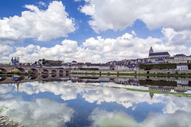 Blois, Loire Valley, France: Blois skyline, city on the shores of Loire River with Jacques Gabriel bridge, capital of Loir-et-Cher department in central France, dramatic cloudscape on sunny summer day