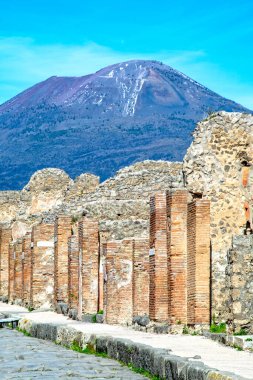 İtalya 'daki Pompeii antik Roma şehrinde sokak ve binalar. Vezüv Dağı 'nda (arka planda görülen) 79 yılında volkanik patlamayla yok edildi.