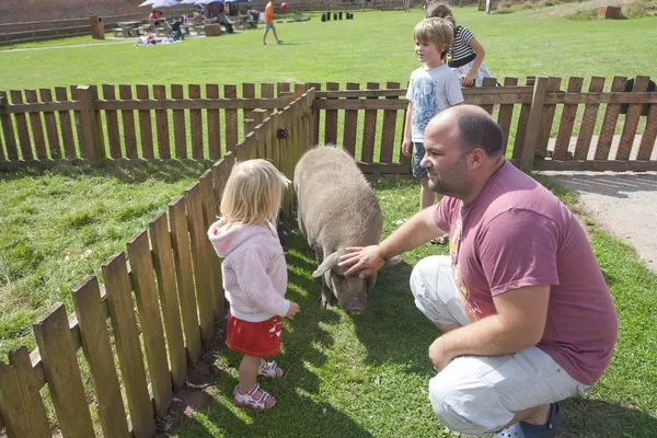 Family at a farm, dad and children — Stock Photo, Image