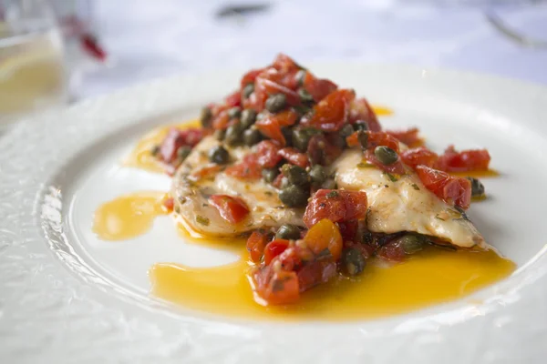 Roasted sea bass with tomatos and capers — Stock Photo, Image