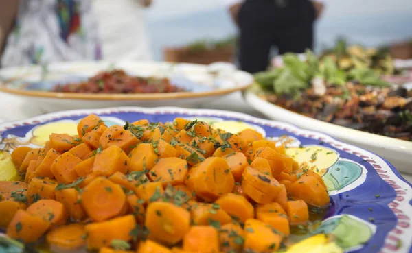 Carrots with herbs and butter or oil at an italian buffet — Stock Photo, Image