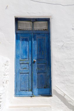 Wooden blue door in greece clipart