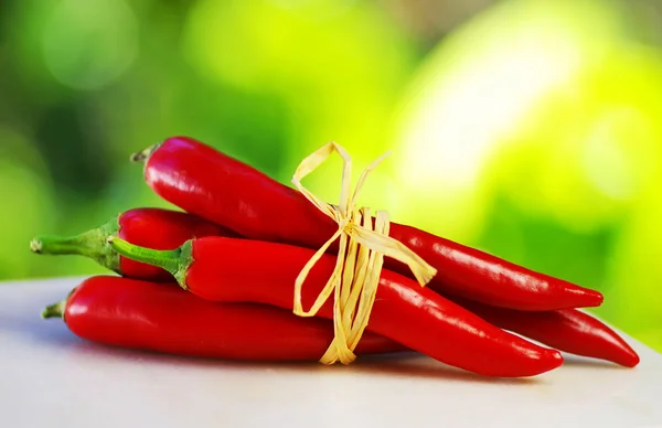 Red hot chili peppers tied with rope — Stock Photo, Image