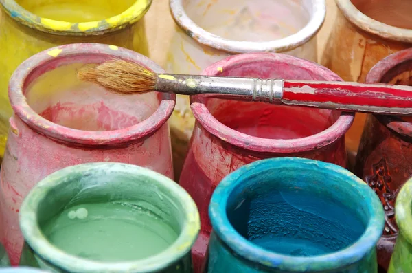 Old brush and colorful bottles — Stock Photo, Image