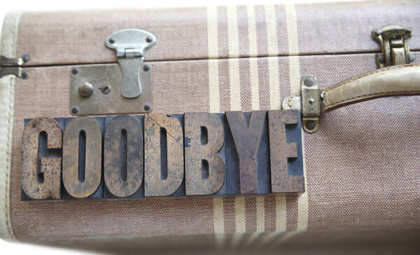 Goodbye word on vintage suitcase