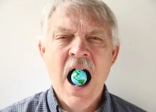 Man with earth model in his mouth — Stock Photo, Image