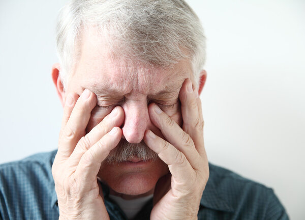 senior suffering from sinus pressure