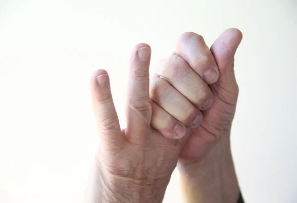 Man with soreness in his fingers Royalty Free Stock Images