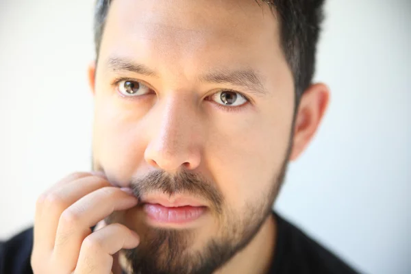 Young man scratching his beard — Stock Photo, Image